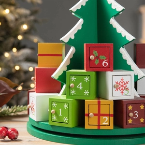 Green wooden Christmas tree advent calendar with numbered drawers and festive ornaments