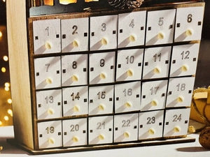 Wooden advent calendar house with 24 white drawers and LED lighting for Christmas