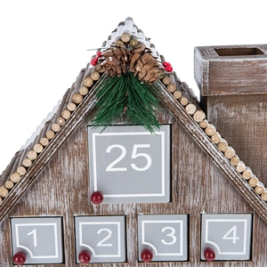 Nordic wooden Christmas advent calendar house with festive pine and berry decorations