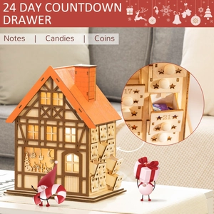 Detail of wooden advent calendar house with warm LED lights and 24 countdown drawers
