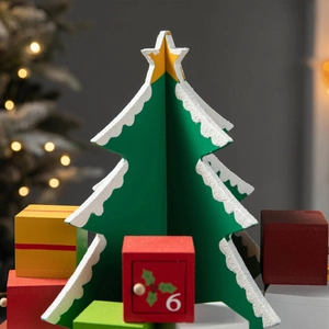 Wooden Christmas tree countdown calendar with 24 numbered gift boxes and snow texture