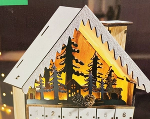 White wooden house Advent calendar with 24 drawers and warm LED silhouette lights