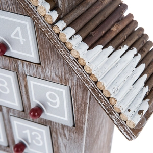 Macro view of wooden advent calendar with snowy roof texture and small numbered drawers