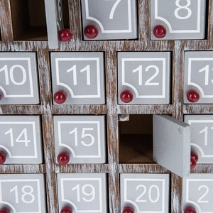 Luminous wooden advent calendar with gray drawers and red knobs for Christmas decor