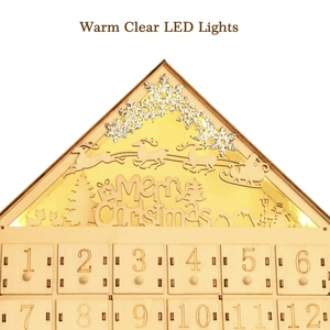 Detailed laser-cut Merry Christmas engraving with warm LED light on wooden advent calendar