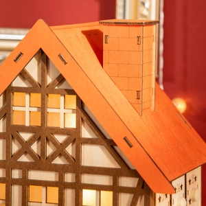 Macro view of Christmas wooden house advent calendar with numbered candy drawers