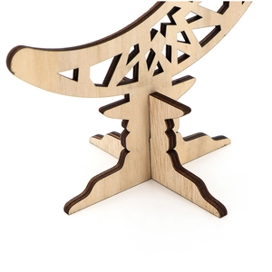 Detail of laser-cut wooden base with cross-assembly design and hollow geometric patterns
