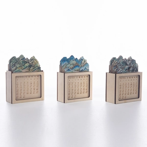 Detailed laser-cut mountain landscape on a 2023 wooden perpetual desk calendar
