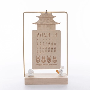 Wooden Chinese Zodiac Rabbit calendar with 2023 dates and metal frame on a desk base