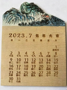 Miniature wooden desk calendar with Chinese landscape carving and 2023 monthly display