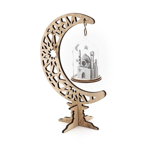 Detail view of wooden crescent moon frame with hollow patterns and a glass mosque globe