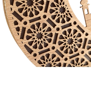 Detail of laser-cut wooden crescent moon with geometric star and mosque silhouette