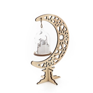 Close-up of wooden crescent moon ornament with carved patterns and glass cloche detail