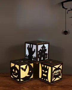 Three Halloween LED wooden lantern boxes with laser-cut spooky silhouettes on tabletop