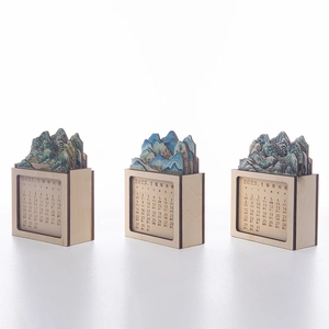 Detail of wooden 3D desk calendar with landscape carvings and Chinese rabbit year motifs