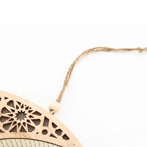 Detailed view of laser-cut wooden moon lamp showing geometric star patterns and natural rope