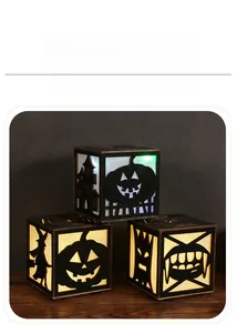 Three hollowed-out wooden Halloween lanterns with glowing pumpkin and witch silhouettes