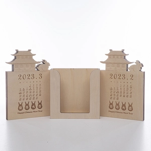 Close-up of laser-engraved wooden desk calendar with Chinese pavilion and rabbit design