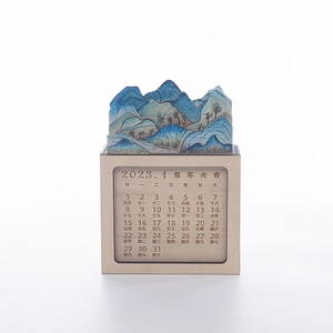 Detailed macro view of 3D layered landscape art on a wooden perpetual desk calendar