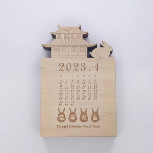 Macro shot of 2023 wooden calendar with laser-cut rabbit and Chinese palace design