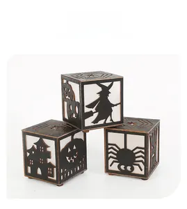 Detail of Halloween wooden hollow cubes with carved witch, spider and pumpkin patterns