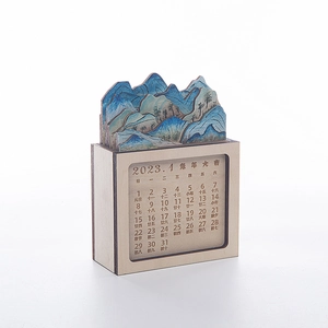 Detailed macro view of creative wooden 2023 landscape calendar with 3D mountain layers