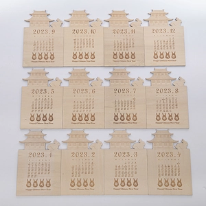 Macro detail of 12 laser-cut wooden calendar plates with 2023 Rabbit Year Chinese motifs