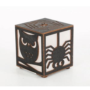Detailed laser-cut pattern of owl and spider silhouettes on Halloween wooden lantern