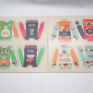 Detailed view of eight customized wooden Christmas sweater ornaments with name engravings