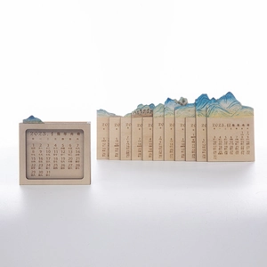 Creative 2023 wooden perpetual calendar with blue landscape art and mountain cutouts