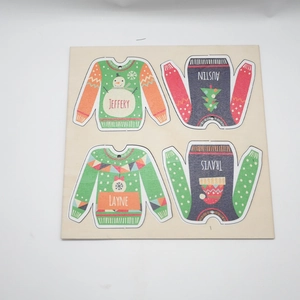 Detailed laser-cut wooden Christmas sweater ornaments with custom names and festive patterns