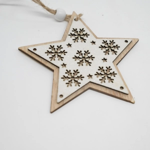 Close-up of star wooden ornament with white glitter and snowflake hollow carvings