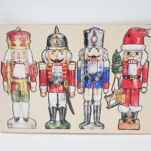 Detailed view of four painted wooden nutcracker and Santa Claus hanging ornaments
