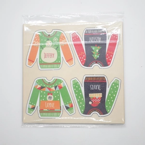 Close-up of four custom wooden Christmas sweater ornaments with name engravings