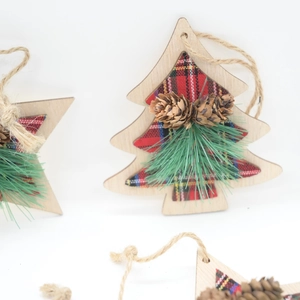 Detail of wooden Christmas ornaments with pine cones and red buffalo plaid fabric
