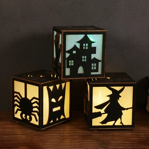 Three creative Halloween wooden pumpkin lanterns with spooky cutouts and warm glow