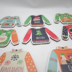 Customized wooden sweater-shaped Christmas ornaments with engraved names and festive icons