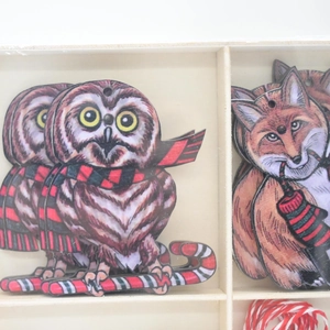 Wooden Christmas animal ornaments set with owls and foxes in a natural wooden box
