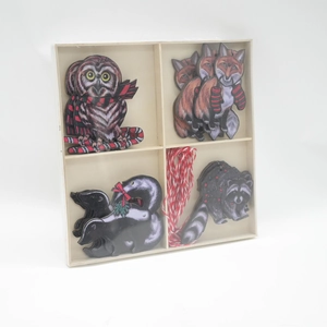 Wooden Christmas animal ornaments set with owl, fox, and raccoon in a wooden box