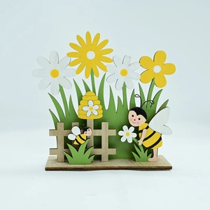 Detail of layered wooden Easter bumblebee ornament with daisies and rustic fence