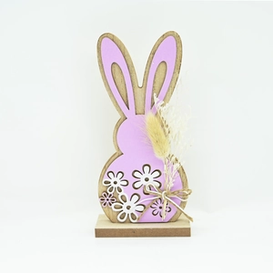 Detail of wooden Easter bunny decor with purple panels, dry flowers and hemp bow