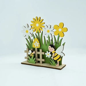 Detail of laser-cut wooden Easter bee ornament with white daisies and garden fence