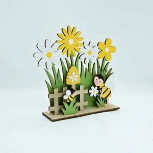 Detail of laser-cut wooden Easter garden ornament with bees, daisies and honeycomb