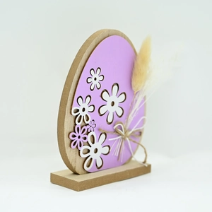 Detailed side view of a purple Easter egg wooden ornament with white floral hollow patterns