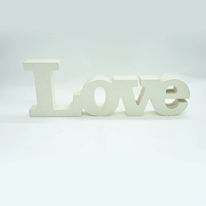 Detailed close-up of white LOVE wooden letter sign with matte finish for wedding decor