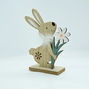 Detail of wooden Easter bunny ornament with soft feather neck and a small white flower