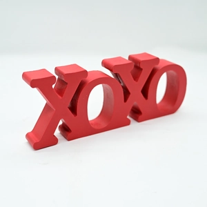 Macro view of matte red XOXO wooden letter sign for Valentine's Day decor