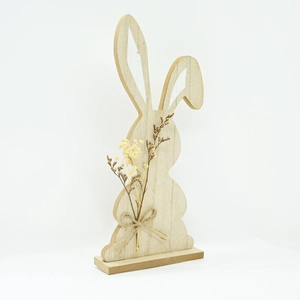 Detail of wooden Easter bunny with dried flower bouquet and rustic jute bow ornament