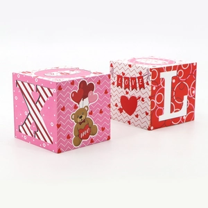 Detailed view of Valentine wood cube decor with romantic bear and love heart patterns