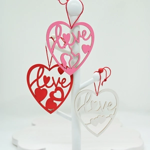 Three heart-shaped wooden pendants in red, pink, and white with artistic Love lettering